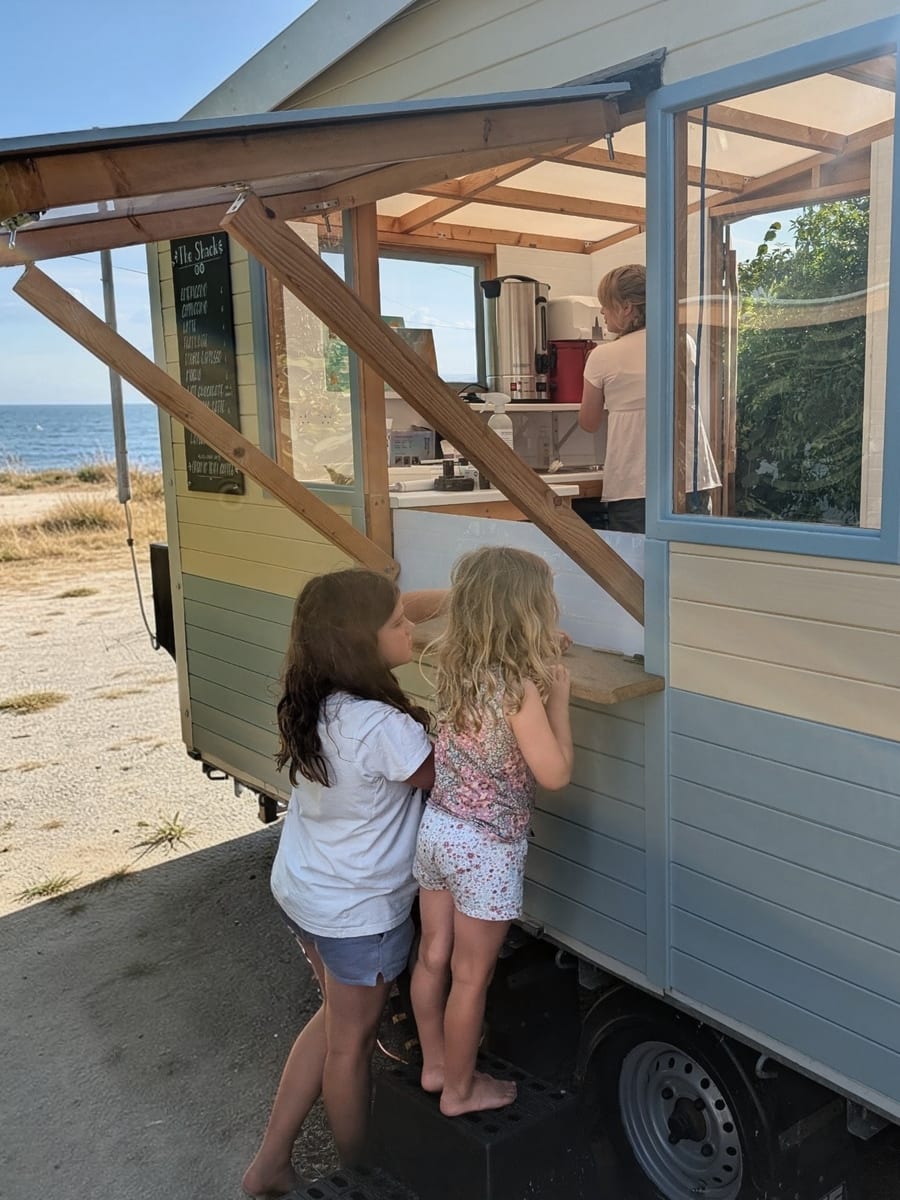 Friends enjoying food around a mobile catering van