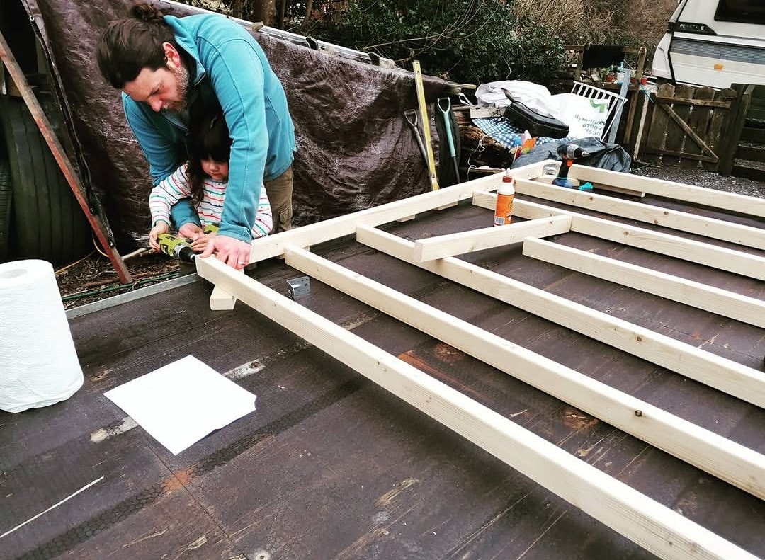 Family members building the first timber frame for The Shack on Wheels