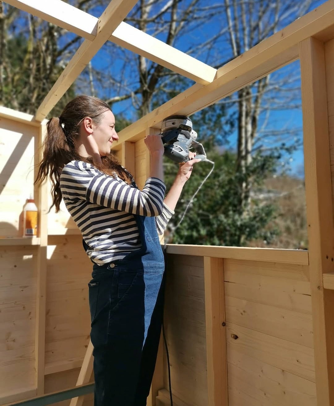 Using a power tool to build the wooden Shack frame